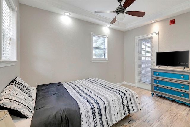 bedroom with ceiling fan, light wood-type flooring, and crown molding