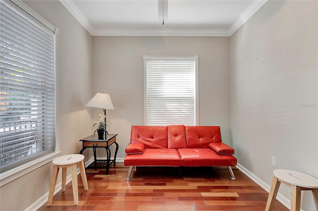 living area featuring ornamental molding and hardwood / wood-style floors