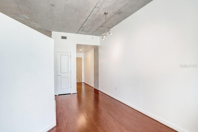 unfurnished room with dark hardwood / wood-style floors