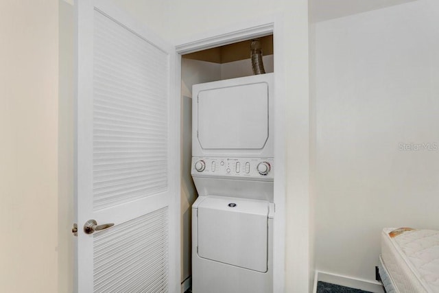 laundry room featuring stacked washer and clothes dryer