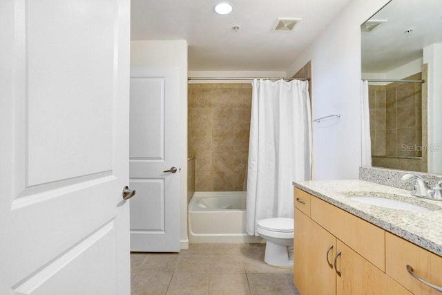 full bathroom with tile patterned floors, vanity, shower / tub combo, and toilet