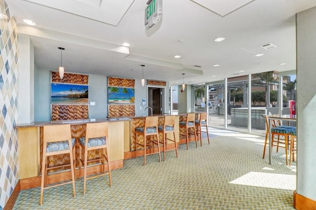 bar with carpet flooring and decorative light fixtures