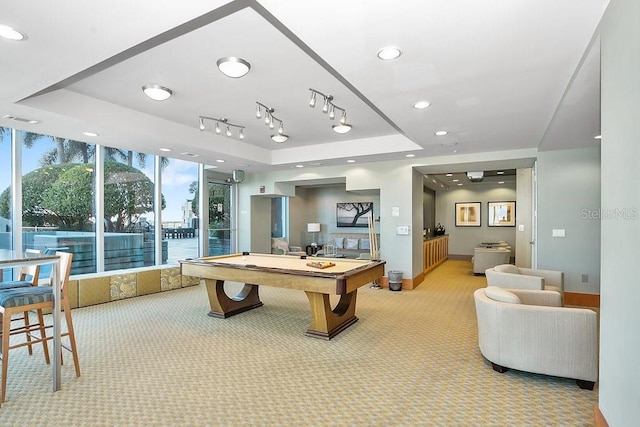 recreation room featuring light colored carpet, billiards, and a tray ceiling