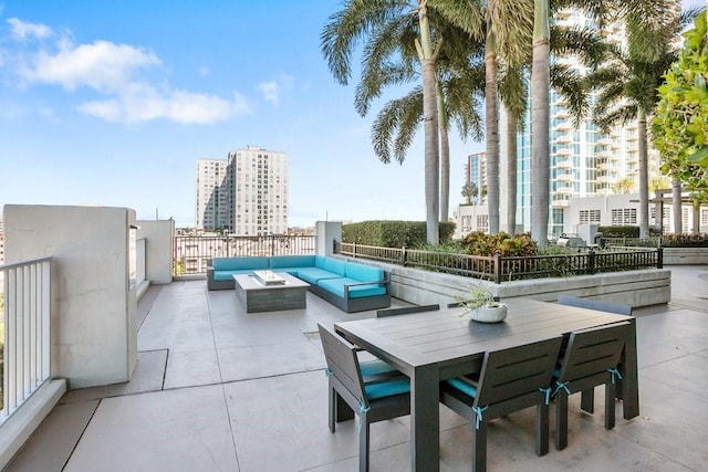 view of patio featuring an outdoor living space with a fire pit