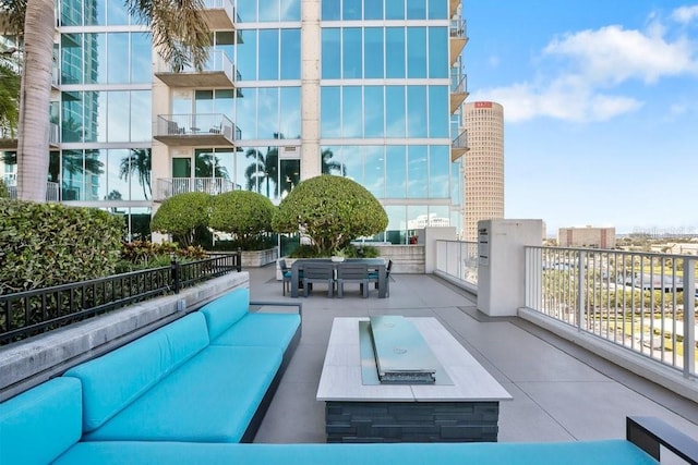 view of swimming pool with a patio area and an outdoor living space with a fire pit