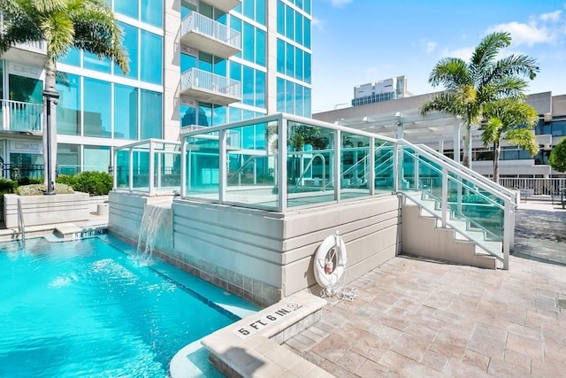 view of pool with pool water feature