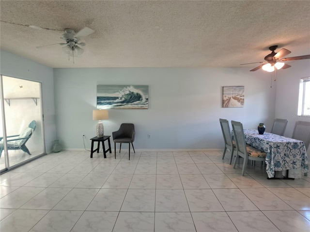 dining room featuring a textured ceiling and ceiling fan