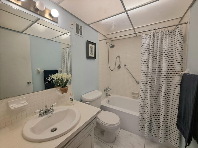 full bathroom with shower / tub combo, decorative backsplash, vanity, and toilet