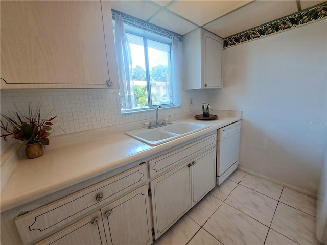 kitchen featuring decorative backsplash, white dishwasher, light tile patterned flooring, and sink