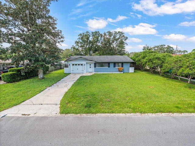 single story home with a garage and a front lawn