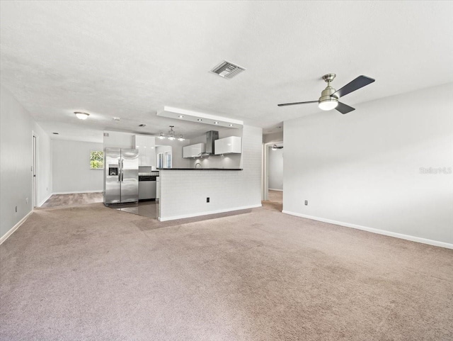 unfurnished living room featuring ceiling fan and light carpet