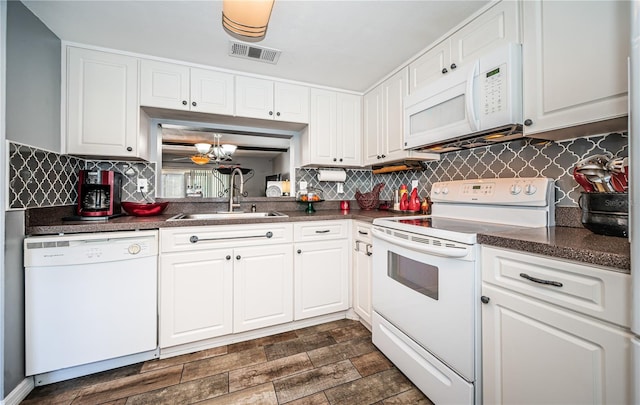 kitchen with white appliances, sink, and white cabinets