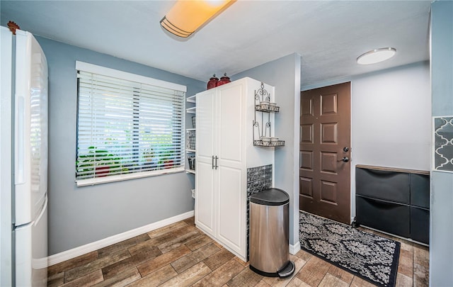 interior space with dark hardwood / wood-style flooring and white cabinetry