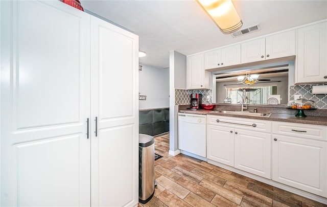 kitchen with decorative backsplash, dishwasher, light hardwood / wood-style flooring, and white cabinets