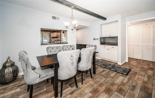 dining space with beam ceiling, an inviting chandelier, and dark wood-type flooring