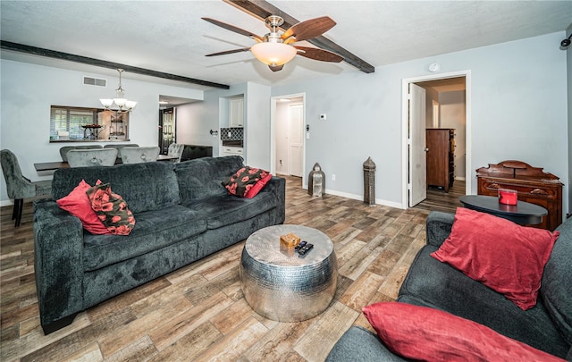 living room with a textured ceiling, ceiling fan with notable chandelier, and hardwood / wood-style floors