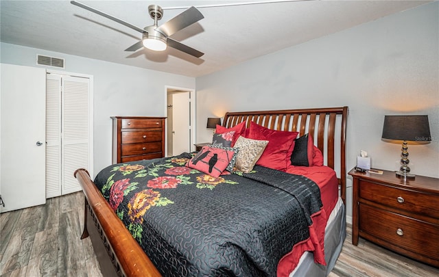 bedroom featuring ceiling fan, hardwood / wood-style flooring, and a closet