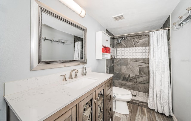 bathroom featuring wood-type flooring, a shower with curtain, vanity, and toilet