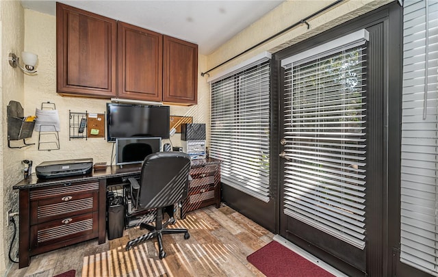 home office with light hardwood / wood-style floors