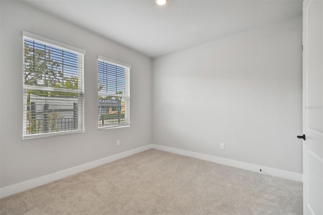 carpeted empty room featuring a healthy amount of sunlight