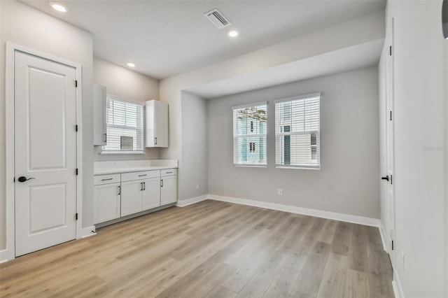 interior space featuring light hardwood / wood-style flooring and multiple windows