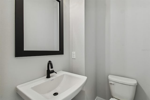 bathroom featuring sink and toilet