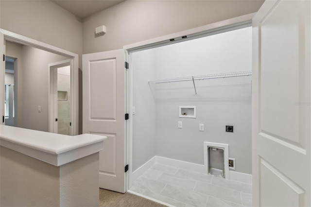 washroom with hookup for an electric dryer, light tile patterned flooring, and washer hookup