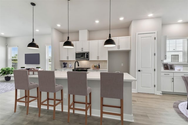 kitchen featuring a center island with sink, plenty of natural light, and appliances with stainless steel finishes