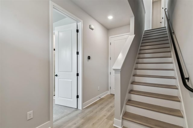 stairway with hardwood / wood-style floors