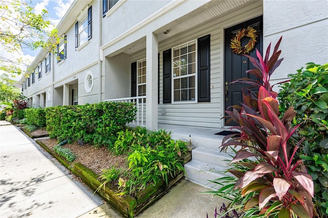 view of property exterior featuring stucco siding and covered porch