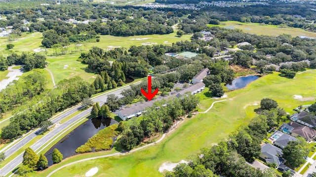 drone / aerial view with a water view and golf course view