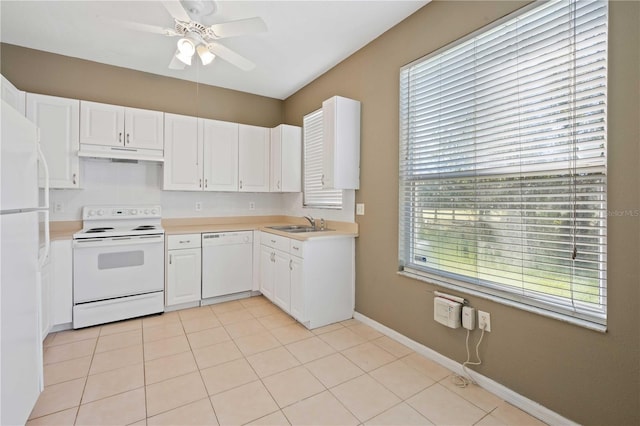 kitchen featuring plenty of natural light, white cabinets, and white appliances