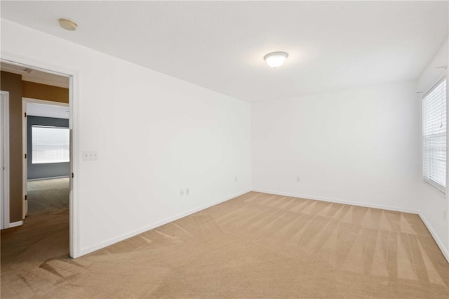 spare room with light carpet