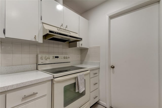 kitchen with white cabinets, tasteful backsplash, and electric stove