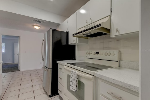 kitchen with decorative backsplash, white range with electric cooktop, white cabinetry, and light tile patterned floors