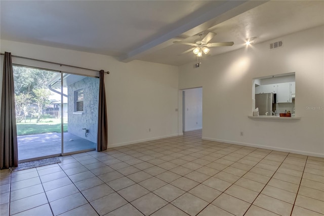 tiled empty room featuring ceiling fan and vaulted ceiling with beams