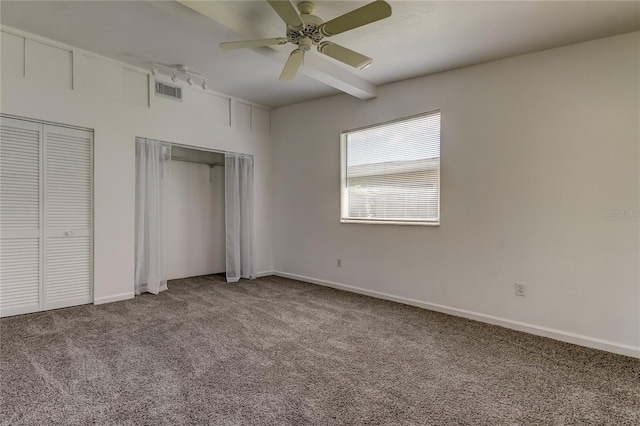 unfurnished bedroom with multiple closets, carpet flooring, and ceiling fan