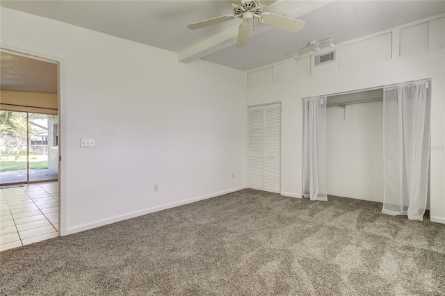 unfurnished bedroom with beamed ceiling, carpet floors, and ceiling fan