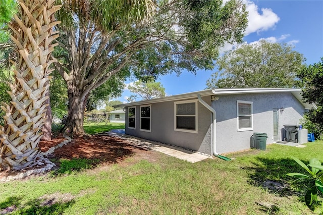 rear view of property featuring a lawn