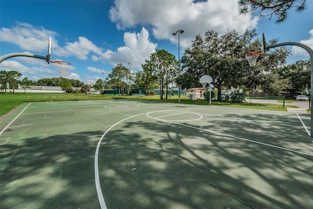 view of basketball court featuring a yard