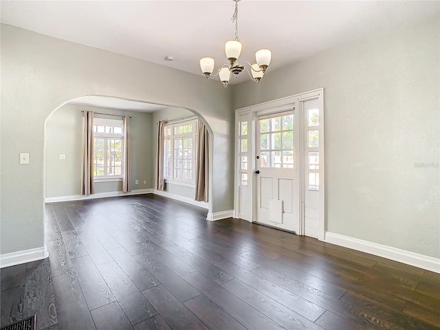 entryway featuring dark hardwood / wood-style floors and a chandelier