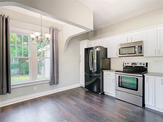 kitchen featuring white cabinets, a notable chandelier, stainless steel appliances, and dark hardwood / wood-style floors