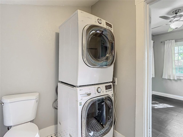 laundry area with ceiling fan, hardwood / wood-style flooring, and stacked washing maching and dryer