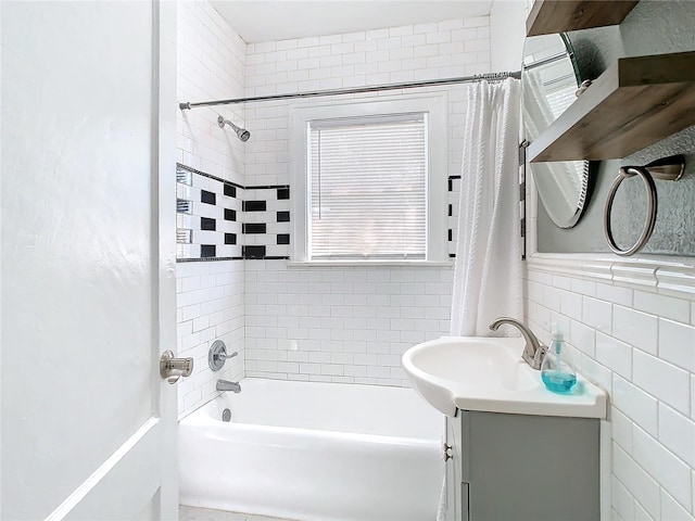 bathroom with vanity, tile walls, and shower / tub combo with curtain