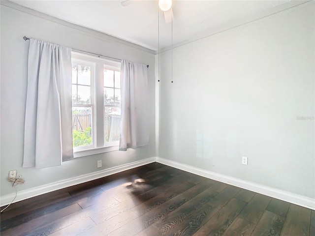 empty room featuring ceiling fan and dark hardwood / wood-style floors