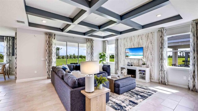 tiled living room with coffered ceiling, a high end fireplace, and a wealth of natural light