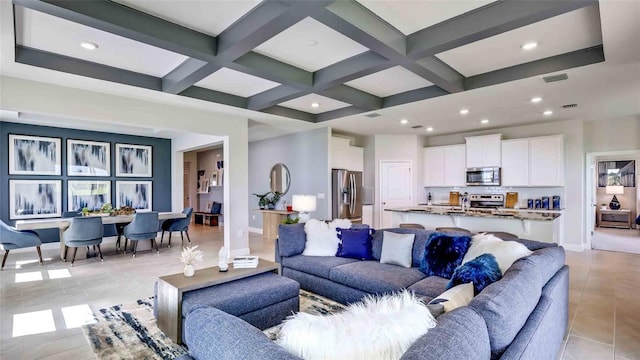 tiled living room featuring coffered ceiling and beamed ceiling