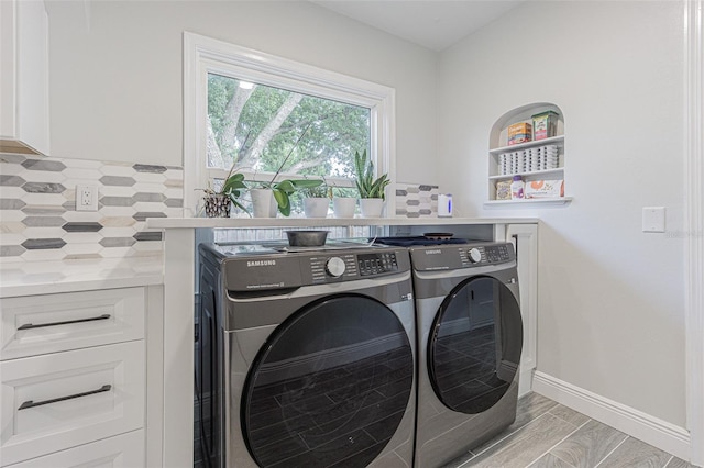 laundry area featuring light hardwood / wood-style floors and washing machine and dryer