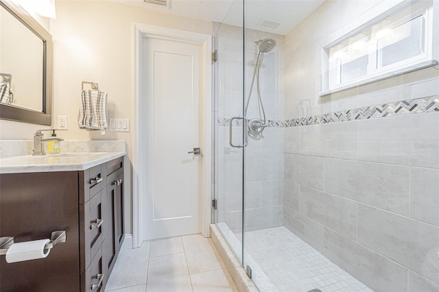 bathroom with tile patterned flooring, vanity, and an enclosed shower