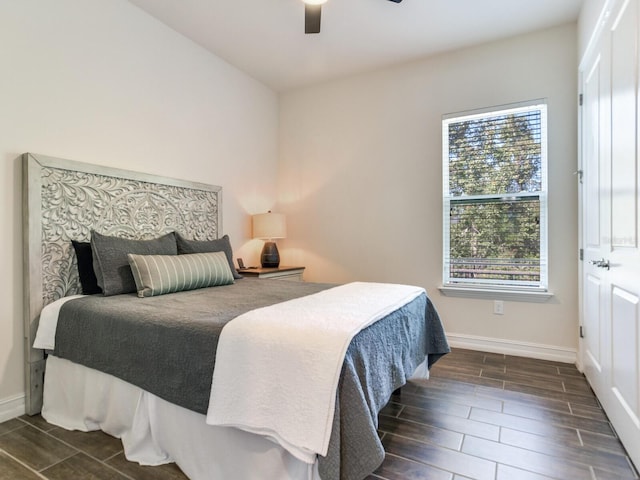 bedroom featuring dark hardwood / wood-style flooring and ceiling fan